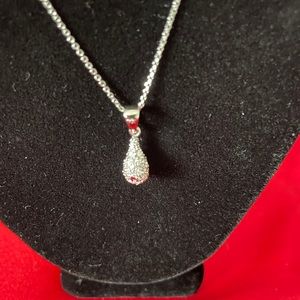 Silver necklace with egg shaped pendent.